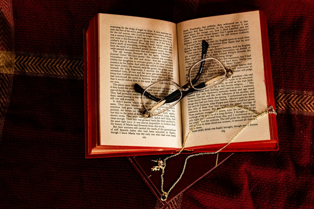Open book with a pair of reading glasses