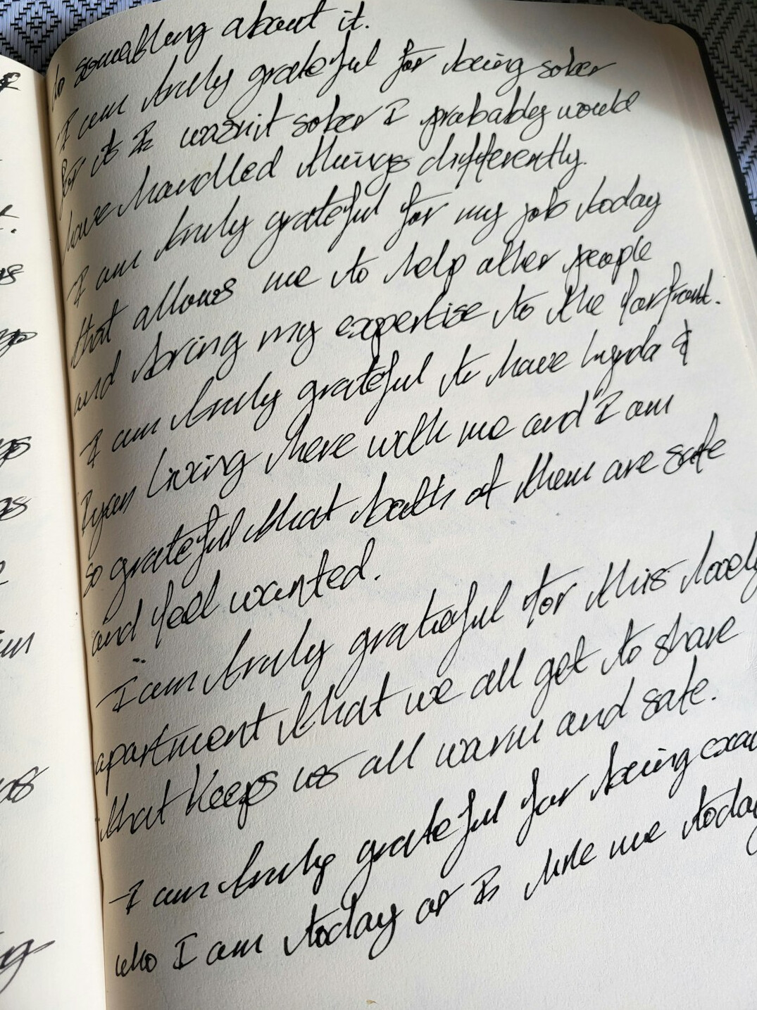 Handwritten notes in a notebook next to a pen