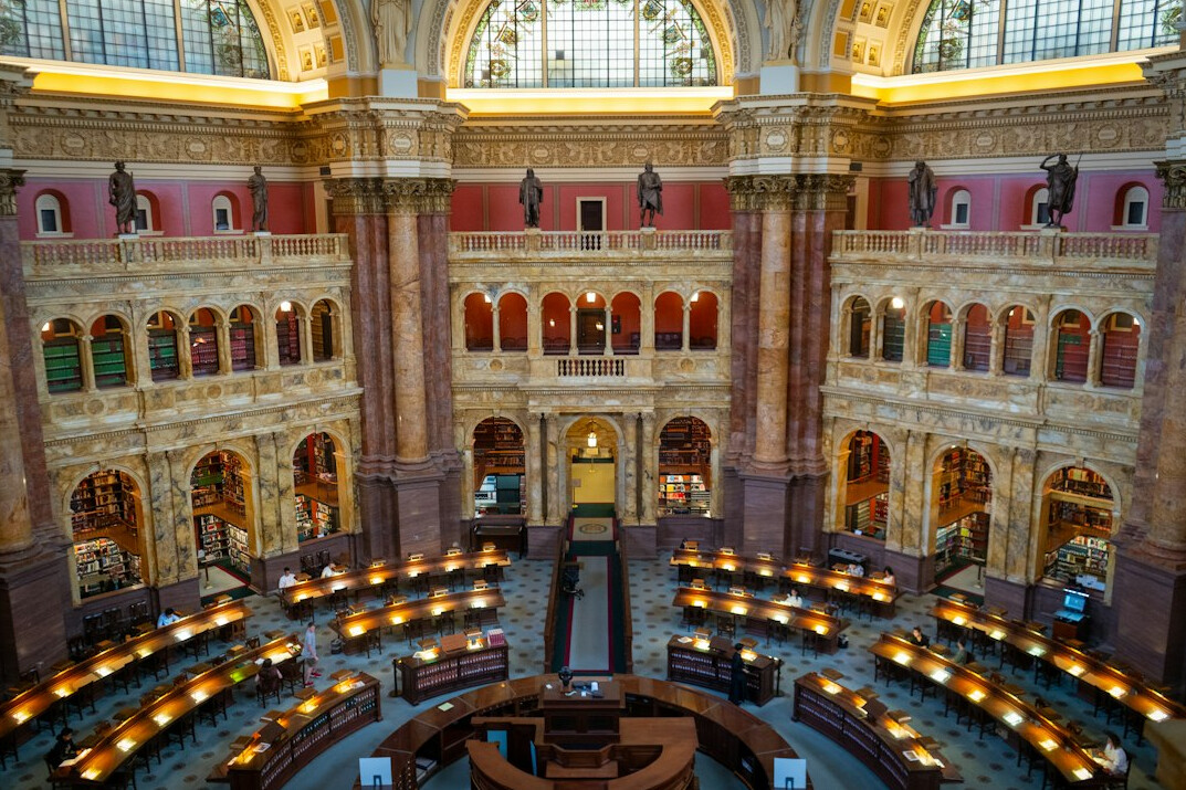 Grand library hall with bookshelves and reading tables